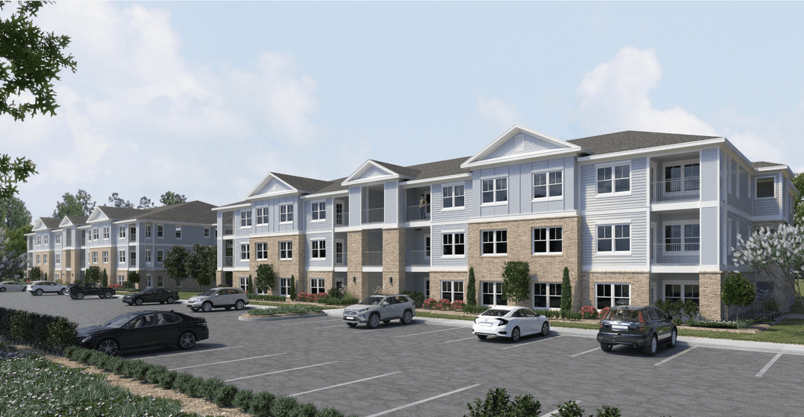 Rendering of a three-story multifamily building and parking lot